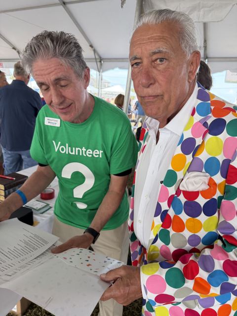 Michael Garey, in volunteer green, with a Lawn Party guest
